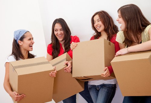 Professional moving crew with a removal truck in a busy urban setting